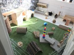 an indoor play area with lots of toys on the ground and in front of a window