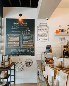 the inside of a coffee shop with menus on the wall