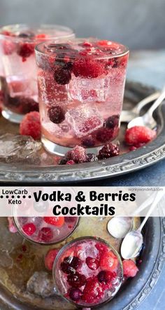 two glasses filled with ice and raspberries on top of a metal tray