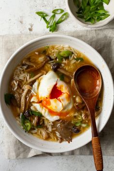 a bowl of soup with an egg on top