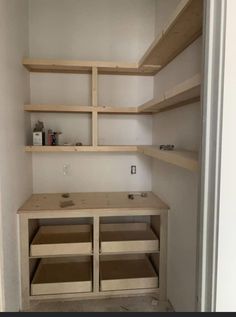 an empty closet with shelves and drawers