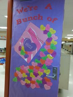 a bulletin board with gummy bears on it in a store aisle, next to a sign that says we're a bunch of gummy