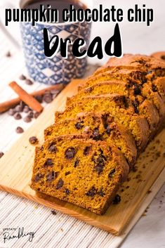 pumpkin chocolate chip bread on a cutting board with coffee and cinnamon sticks in the background