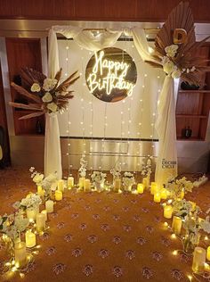 a birthday party with candles and flowers on the floor