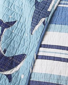 a blue quilt with two dolphins on it