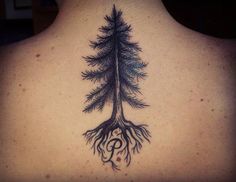 the back of a person's neck with a tree tattoo on it