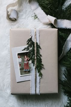 a present wrapped in brown paper and tied with twine on top of white fur