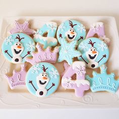 frozen princess cookies decorated with royal icing and snowflakes on a white platter