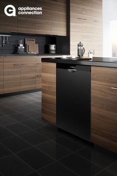 a kitchen with black tile flooring and wooden cabinetry on the wall, along with a dishwasher