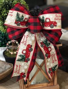 a christmas lantern with a red truck and pine tree on it