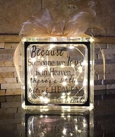 a lighted glass block with a poem on it that says because someone we tree is in heaven there's a light to be