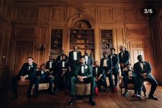 a group of men in tuxedos posing for a photo