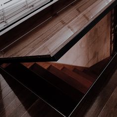 a wooden table with glass top on the floor