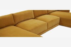 a large sectional couch sitting on top of a white floor