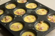 a muffin tin filled with cupcakes covered in ham and cheese toppings