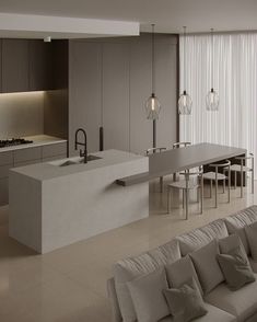 a modern kitchen with an island countertop and seating area in the middle of it