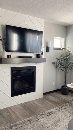 a flat screen tv mounted above a fireplace in a living room