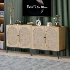 a living room with green walls and a television on top of a wooden entertainment center