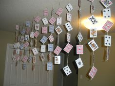 several cards are hanging from the ceiling in front of a door with lights on them