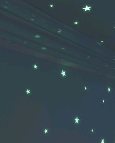 there are many stars on the wall and one is green with white lights in it