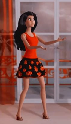 a woman in an orange top and black floral skirt is standing with her arms out