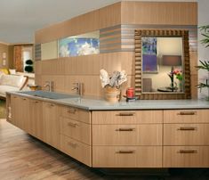 a modern kitchen with wooden cabinets and stainless steel counter tops is pictured in this image