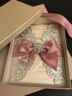 an open box with a pink bow on it