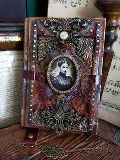 an altered photo frame sitting on top of a table next to music sheets and books