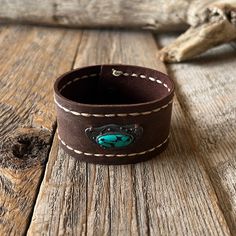 Thank You For Your Interest In Our Handmade Bags, Keychains, And Wallets. We Take Great Pride In The Quality And Craftsmanship Of Our Products. Please Note That The Prices For These Items Are Set And Non-Negotiable. Thank You For Your Understanding And Support. Handmade By Anka Leather Cuff Bracelet Hand Stitched Sides With Faux Turquoise Charm Size: 8” Material: Leather Color: Brown Brown Rectangular Jewelry, Western Style Brown Cuff Bracelet As Gift, Handmade Western Brown Cuff Bracelet, Brown Concho Bracelets As Gift, Vintage Handmade Bracelets For Everyday Use, Handmade Western Style Brown Cuff Bracelet, Handmade Bohemian Leather Bracelet For Everyday, Bohemian Handmade Leather Bracelet For Everyday Use, Everyday Leather Jewelry In Rectangular Shape