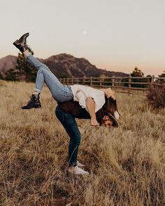 a person is doing a handstand in a field