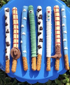 a blue plate topped with lots of different types of candy canes on top of each other