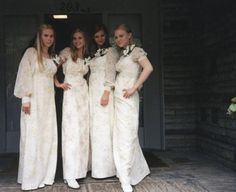 four bridesmaids in white dresses posing for a photo