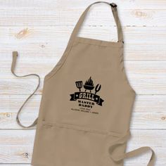 an apron with the words grill nation written in black on it, next to a wooden table