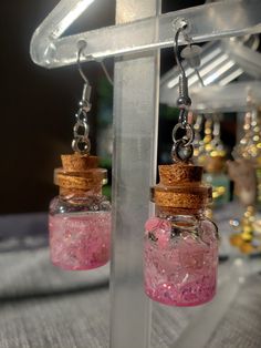 Gorgeous handmade earrings that will give just the right amount of wow-factor. Every stone, jar, flower, herb,  or any ingredient is always cleansed before assembling. A clear mind and positive intentions fill the space while building. Fairy Jar Earrings, Handmade Pink Fantasy Jewelry, Nickel-free Magical Earrings For Gift, Magical Nickel-free Earrings For Gifts, Magical Handmade Dangle Earrings, Handmade Magical Dangle Earrings, Unique Crystal Earrings As Gift, Unique Crystal Earrings For Pierced Ears As Gift, Unique Pierced Crystal Earrings For Gift