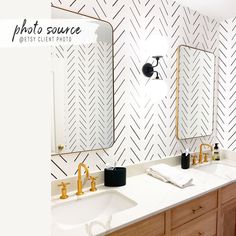 the bathroom is decorated in black and white herringbones, with gold faucets