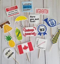 some stickers that are sitting on top of a wooden table with flags and umbrellas