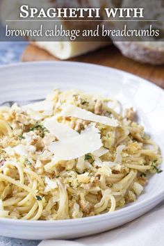 spaghetti with browned cabbage and breadcrumbs on a white plate