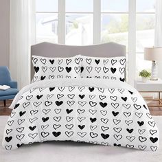 a bed with black and white hearts on it