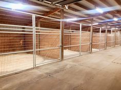 the inside of an empty storage building with metal bars and gates on each side of the fence