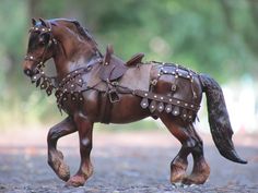 a statue of a horse is shown in the middle of the road with chains on it's back legs