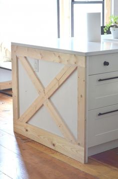 the kitchen island is made out of wood and has a sliding barn door on it