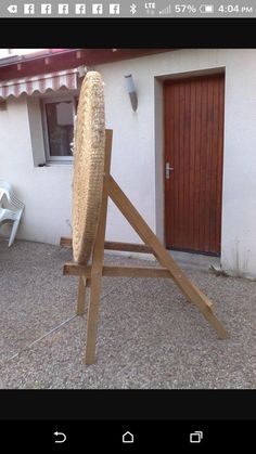 an ironing board leaning against the side of a house