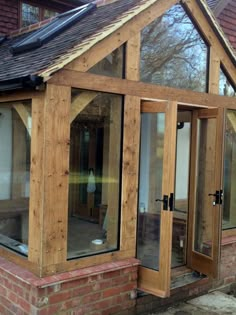 a wooden building with glass doors and windows