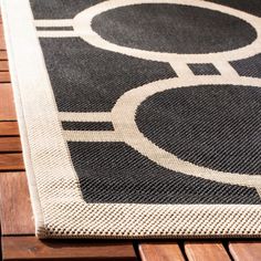 a black and white rug sitting on top of a wooden table