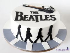 there is a cake with the beatles on it that looks like they are going to rock