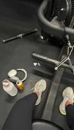 a person sitting on a bench with their feet propped up next to an exercise machine