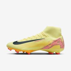 the nike meron fg soccer shoe is shown in yellow, pink and black