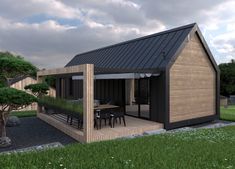 a small wooden house with a patio and picnic table in the grass next to it