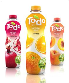 three bottles of juice with oranges and pomegranate