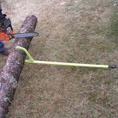 a man using a chainsaw to cut a log